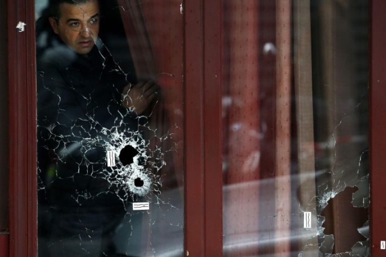 A man looks outside the Carillon cafe with bullets holes on the glasses, in Paris, France, 14 November 2015. At least 120 people have been killed in a series of attacks in Paris on 13 November, according to French officials. Eight assailants were killed, seven when they detonated their explosive belts, and one when he was shot by officers, police said. French President Francois Hollande says that the attacks in Paris were an 'act of war' carried out by the Islamic State extremist group.