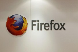 A man is seen next to a Firefox logo at a Mozilla stand during the Mobile World Congress in Barcelona, in this February 28, 2013 file picture. A paper released by the mobile industry's GSM Association ahead of this week's congress in Barcelona noted that at least 36 telecoms operators had pledged support for one of the four open source challengers - Firefox, Ubuntu, Tizen and Sailfish. But the GSMA said that if anyone is to make a dent it needs to win at least 5 percent market share within the next year or so "to have a chance of being a long-term competitor." Leading the charge at Barcelona is Mozilla Corp, best known for its open source Firefox browser, and whose Firefox mobile OS is already on three devices sold by four operators in more than a dozen markets. To match story MOBILE-WORLD/OS REUTERS/Albert Gea/Files (SPAIN - Tags: SCIENCE TECHNOLOGY BUSINESS TELECOMS)