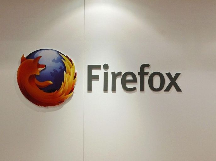 A man is seen next to a Firefox logo at a Mozilla stand during the Mobile World Congress in Barcelona, in this February 28, 2013 file picture. A paper released by the mobile industry's GSM Association ahead of this week's congress in Barcelona noted that at least 36 telecoms operators had pledged support for one of the four open source challengers - Firefox, Ubuntu, Tizen and Sailfish. But the GSMA said that if anyone is to make a dent it needs to win at least 5 percent market share within the next year or so "to have a chance of being a long-term competitor." Leading the charge at Barcelona is Mozilla Corp, best known for its open source Firefox browser, and whose Firefox mobile OS is already on three devices sold by four operators in more than a dozen markets. To match story MOBILE-WORLD/OS REUTERS/Albert Gea/Files (SPAIN - Tags: SCIENCE TECHNOLOGY BUSINESS TELECOMS)