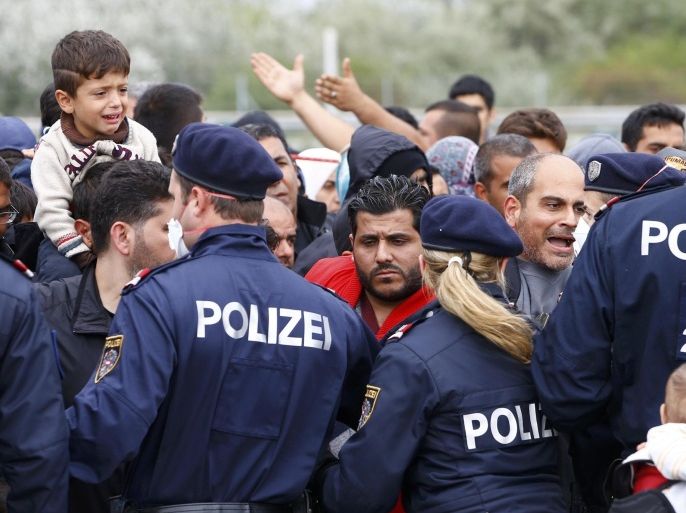 Police maintain order as migrants attempt to leave the border crossing in Nickelsdorf, Austria September 14, 2015. Austria announced on Monday it would dispatch the armed forces to guard its eastern frontier, following Germany's lead in reimposing Europe's internal border controls after thousands of migrants streamed across its frontier from Hungary on foot. REUTERS/Leonhard Foeger