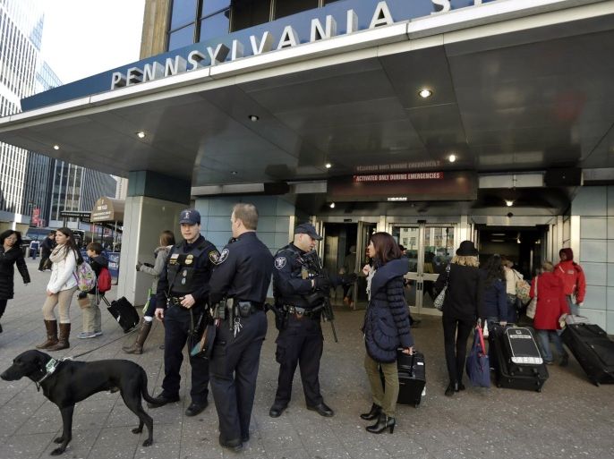 Amtrak Police Dept. officers work outside New York's Pennsylvania Station, Wednesday, Nov. 25, 2015. An estimated 46.9 million Americans are expected to take a car, plane, bus or train at least 50 miles from home over the long holiday weekend, according to the motoring organization AAA. (AP Photo/Richard Drew)