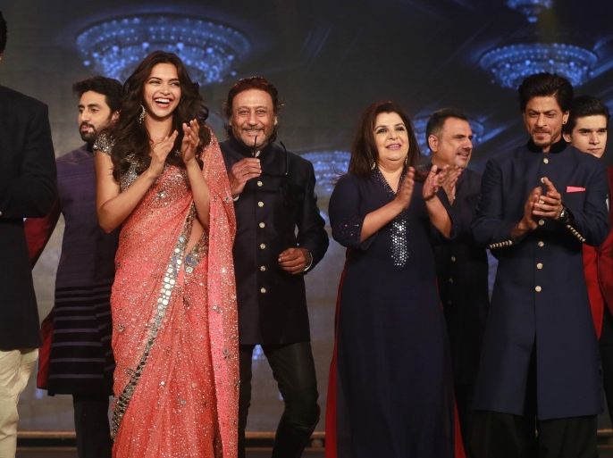 From left to right, Bollywood actors Sonu Sood, Abhishek Bachchan, Deepika Padukone, Jackie Shroff, Director Farah Khan, Boman Irani, Shah Rukh Khan and Vivaan Shah applaud during a promotional event for their upcoming film "Happy New Year" in Mumbai, India, Thursday, Aug. 14, 2014. The film is scheduled for release Oct. 24. (AP Photo/Rafiq Maqbool)