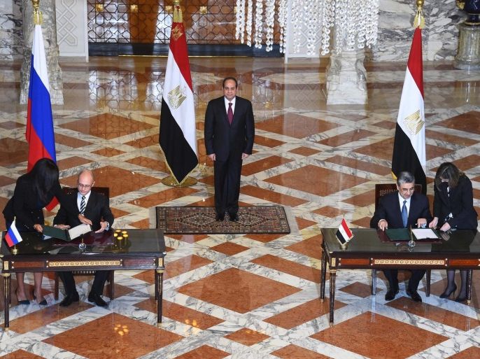 A handout photograph made available by the Egyptian Presidency shows Egyptian President Abdel Fattah al-Sisi (C) looking on as Chief Executive Officer of Russian Rosatom company Sergey Kiriyenko (L, sitting) and Egyptian Minister of Electricity and Renewable Energy Mohamed Shaker (R, sitting) sign a deal to build Egypt's first nuclear power plant, in Cairo, Egypt, 19 November 2015. The deal to build Egypt's first nuclear power plant is estimated at 20 billion dollars. The facility is planned to be built over 12 years in the north-western Egyptian region of El Dabaa and consist of four reactors, each capable of producing 1,200 megawatts of power. EPA/EGYPTIAN PRESIDENCY/HANDOUT