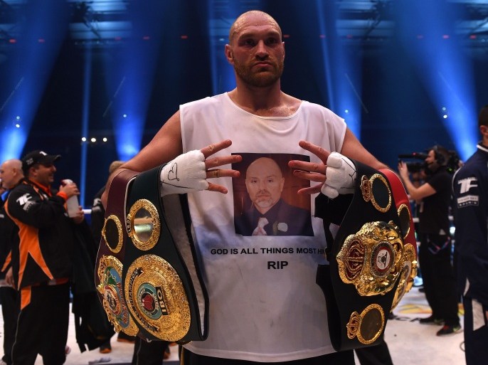 PST017 - Duesseldorf, -, GERMANY : British Tyson Fury celebrates after the WBA, IBF, WBO and IBO title bout against Ukrainian world heavyweight boxing champion Wladimir Klitschko in Duesseldorf, western Germany, on November 28, 2015. Fury won the fight after 12 Rounds of Boxing. AFP PHOTO / PATRIK STOLLARZ
