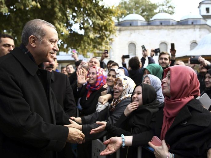 Turkey's President Recep Tayyip Erdogan, left, speaks to supporters after morning prayers at Eyup Sultan Mosque in Istanbul, Turkey, Monday, Nov. 2, 2015. Erdgoan hailed a big victory for his ruling party in parliamentary elections and called on the world to respect it. The ruling Justice and Development party, or AKP, won more than 49 percent of the vote in the snap election, almost double that of the next party in Sunday’s vote. The win restored the single-party majority that it had lost in June elections. (Presidential Press Service/Pool Photo via AP)