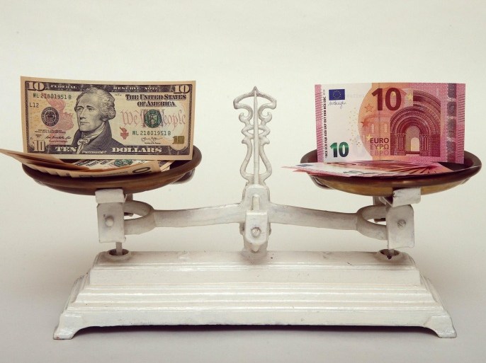 U.S. Dollar and Euro banknotes on a pair of scales in Vienna are seen in this March 11, 2015 file photo. The euro's slide toward parity with the dollar will provide a much-needed boost for European companies this year and force U.S. rivals to adapt their businesses or risk losing market share. REUTERS/Heinz-Peter Bader/Files (AUSTRIA - Tags: BUSINESS) GLOBAL BUSINESS WEEK AHEAD PACKAGE � SEARCH �BUSINESS WEEK AHEAD MARCH 16� FOR ALL IMAGES