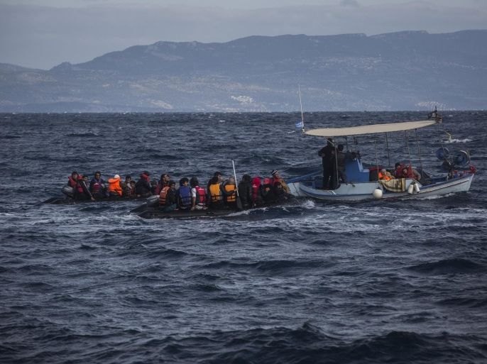 Two dinghies carrying migrants and refugees from nearby Turkey are tugged to safety by a local fishing boat near the village of Skala, on the Greek island of Lesbos, on Sunday, Nov. 1, 2015. Authorities recovered more bodies on Lesbos and the Greek island of Samos Sunday as thousands continue to cross from the nearby coast of Turkey despite worsening weather. Greece is pressing the European Union for additional support for their massive daily search and rescue operations. (AP Photo/Santi Palacios)