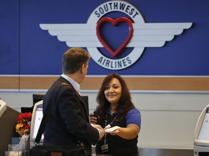 A Southwest Airlines customer service agent assists a passenger ahead of Thanksgiving Holiday at the Midway International Airport in Chicago, Illinois, USA, 21 November 2014.