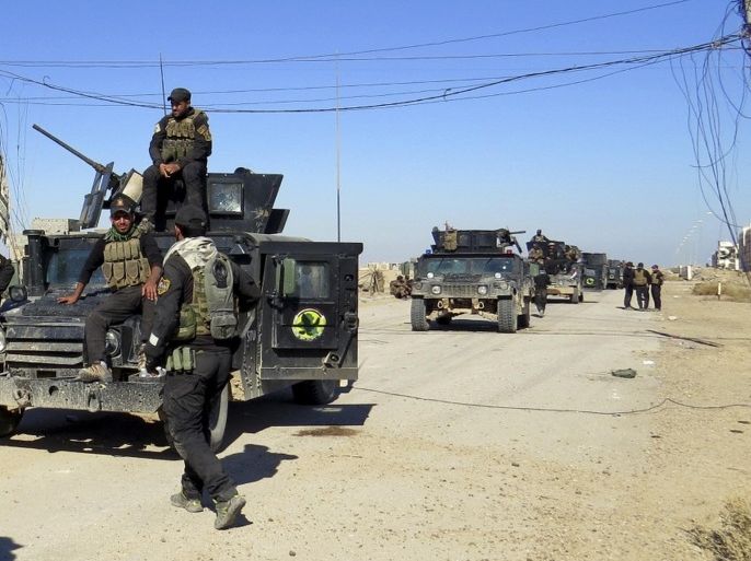 Iraq anti-terrorism forces advance their position after clashes with Islamic State group in the western suburbs of Ramadi, the capital of Iraq's Anbar province, 70 miles (115 kilometers) west of Baghdad, Iraq, Saturday, Nov. 14, 2015. (AP Photo/Osama Sami)