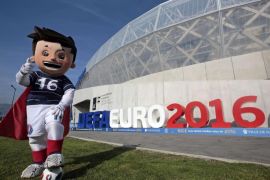 The official Mascot, Super Victor, for the upcoming Euro 2016 soccer championship, poses in front of the UEFA Euro 2016 logo at the Allianz Riviera stadium in Nice, France, October 8, 2015. France will host the 2016 European Championship and the Nice stadium will be one of the 10 venues. REUTERS/Eric Gaillard