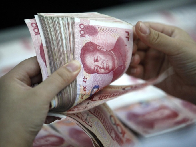 (FILE) A file picture dated 26 August 2015 of a clerk counting Renminbi banknotes in a bank outlet in Huaibei, Anhui province, China. The International Monetary Fund (IMF) on 30 November 2015 announced it is adding China's renminbi, or Yuan, to the currencies that the Washington-based crisis lender uses as a measure of value, alongside the dollar, euro, yen and pound sterling. EPA/WOO HE CHINA OUT *** Local Caption *** 52146007