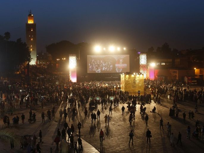 A view of Jamaa Lafna square, where a giant cinema screen has been set up for people to view films for free throughout the annual Marrakech International Film Festival in Marrakech, December 11, 2014. Picture taken on December 11, 2014. REUTERS/Youssef Boudlal (MOROCCO - Tags: ENTERTAINMENT TRAVEL SOCIETY)