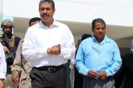 A picture made available 06 October 2015 shows Yemeni Prime Minister Khaled Bahah (L) visiting a school in the southern port city of Aden, Yemen, 05 October 2015. According to reports, a hotel in Yemen's second city of Aden where Prime Minister Khaled Bahah and members of the government are using as residence is on fire on after being hit by three rockets. Bahah was not hurt by the attack.