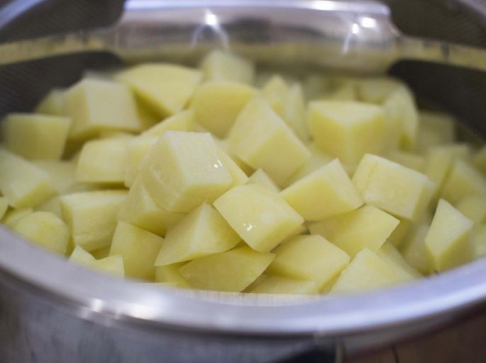 This Oct. 27, 2014 photo shows how to boil potatoes in Concord, N.H. A ricer makes a great tool to mash potatoes, because the quickness with which a ricer forces the cooked potato through its holes keeps the agitation of the starch to a minimum. (AP Photo/Matthew Mead)