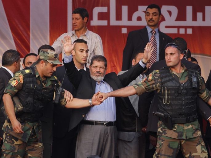 FOR USE AS DESIRED, YEAR END PHOTOS - FILE - In this June 29, 2012 file photo, Egypt's President-elect Mohammed Morsi waves to supporters after giving a speech at Tahrir Square in Cairo. (AP Photo/Khalil Hamra, File)