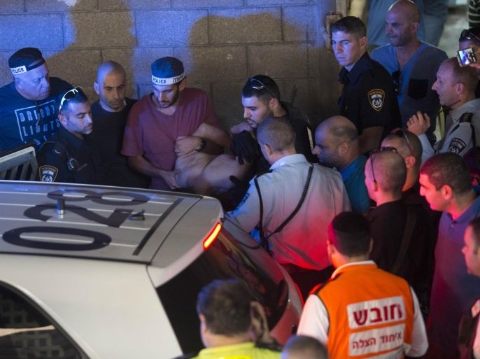 Israeli police arrest a Palestinian identified as Raed Khalil bin Mahmoud, a 36-year-old from the West Bank village of Dura in Tel Aviv, Israel, Thursday, Nov. 19, 2015. Bin Mahmoud fatally stabbed two Israeli men in a Tel Aviv office building on Thursday before being apprehended, police said. (AP Photo/Moti Milrod) ISRAEL OUT