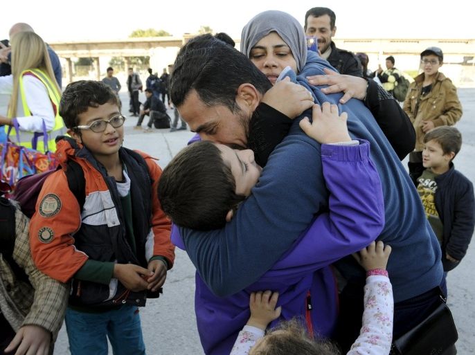 Syrian refugee meets his family after their disembark the Eleftherios Venizelos passenger ship at the port of Piraeus, near Athens,Greece,November,14,2015.The United Nations urged financially strapped Greece on Friday to expand reception centers before winter sets in for refugees and migrants who continue to pour onto the island of Lesbos at a rate of 3,300 every day.REUTERS/Michalis Karagiannis