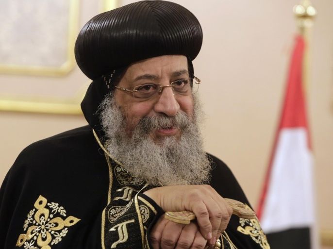 Coptic Pope Tawadros II, the 118th pope of the Coptic Church of Egypt, stands in his office as he receives condolences for Egyptian Christians captured and killed by militants, at St. Mark's Cathedral in Cairo, Egypt, Tuesday, Feb. 17, 2015. The Islamic State group issued a grisly video on Sunday of the beheadings of 21 Egyptian Christians, mainly young men from impoverished families who were kidnapped after traveling to Libya for work.(AP Photo/Amr Nabil)