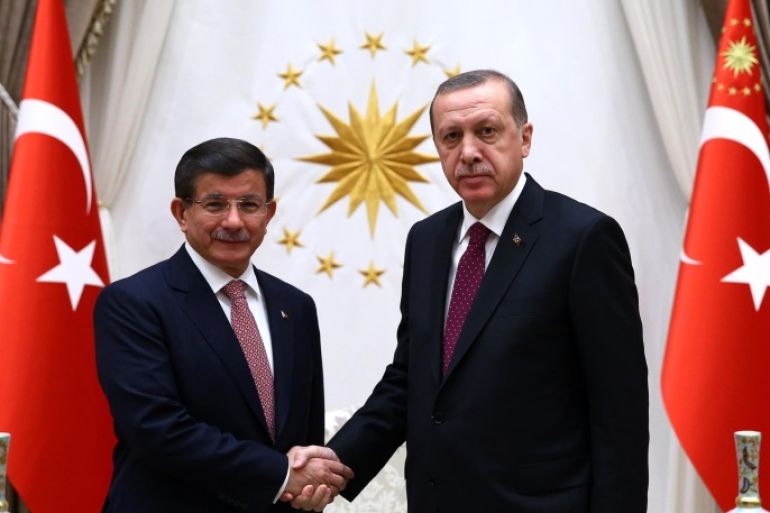 Turkey's Prime Minister Ahmet Davutoglu left, and President Recep Tayyip Erdogan shake hands before a meeting in Ankara, Turkey, Tuesday, Nov. 17, 2015. Erdogan has re-appointed Davutoglu to form a new government after his party's victory in elections on Nov.1.(Presidential Press Service/Pool Photo via AP)