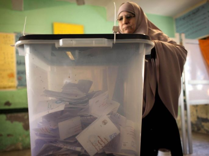 A veiled Egyptian woman casts her vote at a polling station during the second round of a referendum on a disputed constitution drafted by Islamist supporters of President Mohammed Morsi, in Giza, Egypt, Saturday, Dec. 22, 2012. (AP Photo/Nasser Nasser)