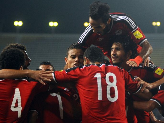 STR010 - Borg El-Arab, -, EGYPT : Egyptian footballers celebrate after scoring a goal during the World Cup qualifying football match between Egypt and Chad in Borg El-Arab near Egypt's northern port city of Alexandria on November 17, 2015. Egypt won the match 4-0. AFP PHOTO
