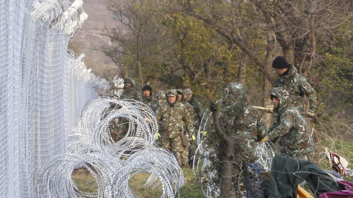 Macedonian Army engineers build a fence on the border line between Macedonia and Greece, near southern Macedonian town of Gevgelija, Saturday, Nov. 28, 2015. Macedonia has started to erect a fence on its southern border with neighboring Greece in order to prevent illegal crossings and to channel the flow of migrants through the official checkpoint, where only migrants from the war-affected zones will be allowed to enter. (AP Photo/Boris Grdanoski)