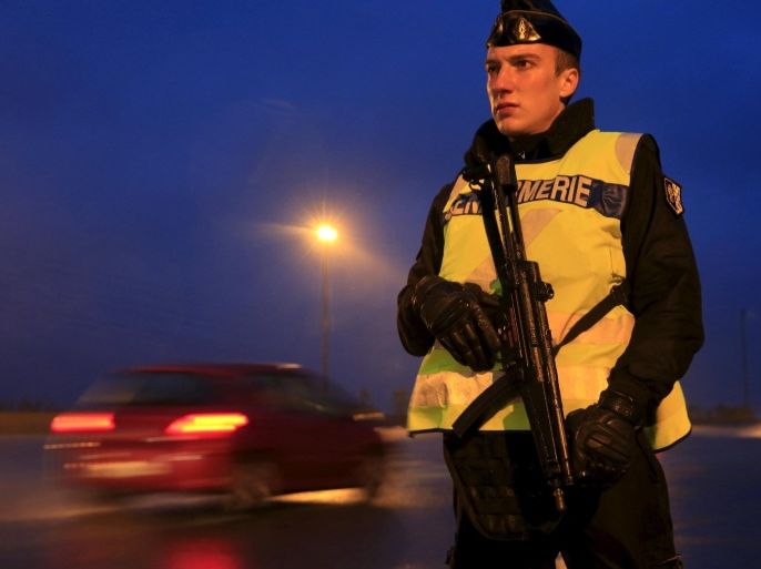 An armed French gendarme stands along the highway as gendarmes check vehicles and verify the identity of travellers on the A2 motorway between Paris-Brussels at the Thun-L'eveque toll station, in France, November 19, 2015, as security increases after last Friday's deadly attacks in the French capital. REUTERS/Pascal Rossignol