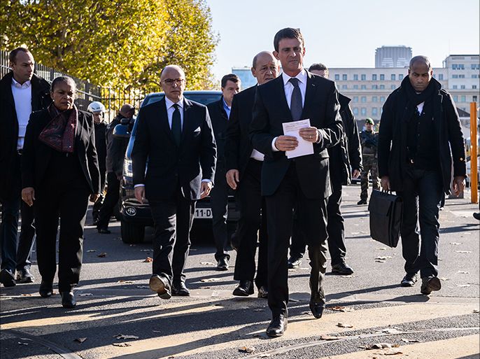 epa05026535 French Prime Minister Manuel Valls (C), French Justice Minister Christiane Taubira (L) and Interior Minister Bernard Cazeneuve (2-L) leave the Ecole Militaire complex where a psychological helping center helps the survivors and families of the victims in Paris, France, 15 November 2015. More than 120 people have been killed in a series of attacks in Paris on 13 November, according to French officials. Eight assailants were killed, seven when they detonated their explosive belts, and one when he was shot by officers, police said. French President Francois Hollande says that the attacks in Paris were an 'act of war' carried out by the Islamic State extremist group. EPA/CHRISTOPHE PETIT TESSON