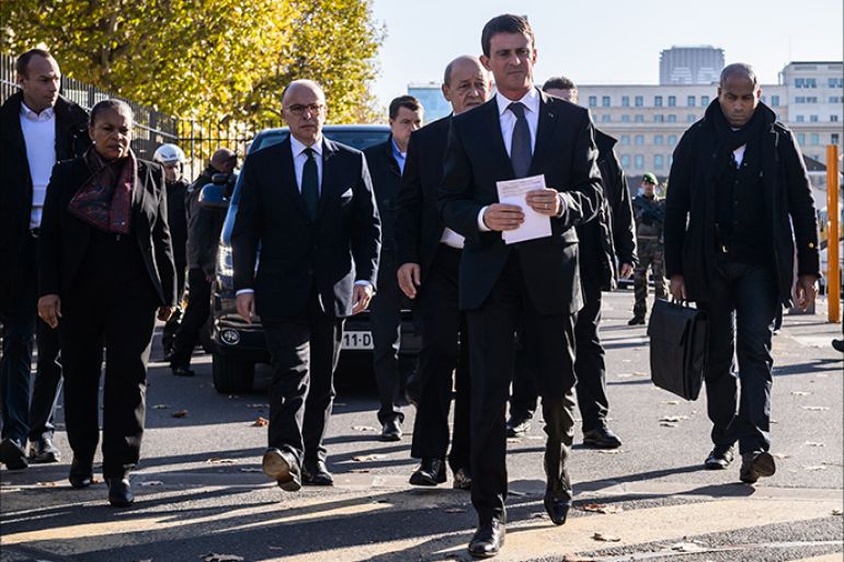 epa05026535 French Prime Minister Manuel Valls (C), French Justice Minister Christiane Taubira (L) and Interior Minister Bernard Cazeneuve (2-L) leave the Ecole Militaire complex where a psychological helping center helps the survivors and families of the victims in Paris, France, 15 November 2015. More than 120 people have been killed in a series of attacks in Paris on 13 November, according to French officials. Eight assailants were killed, seven when they detonated their explosive belts, and one when he was shot by officers, police said. French President Francois Hollande says that the attacks in Paris were an 'act of war' carried out by the Islamic State extremist group. EPA/CHRISTOPHE PETIT TESSON
