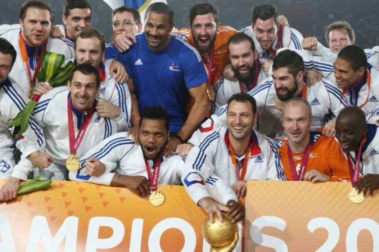 French team players celebrate with the trophy during the podium ceremony of 24th Men's Handball World Championships at the Lusail Multipurpose Hall in Doha, Qatar, Sunday, Feb. 1, 2015. (AP Photo/Osama Faisal)