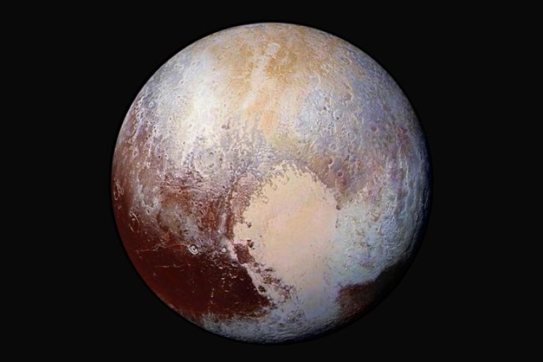 FILE - This image made available by NASA on Friday, July 24, 2015 shows a combination of images captured by the New Horizons spacecraft with enhanced colors to show differences in the composition and texture of Pluto's surface. The images were taken when the spacecraft was 280,000 miles (450,000 kilometers) away. The New Horizons was programmed to fire its thrusters Thursday, Oct. 22, 2015, putting it on track to fly past a recently discovered, less than 30-mile-wide object out on the solar system frontier. The close encounter with 2014 MU69 would occur in 2019. It orbits nearly 1 billion miles beyond Pluto. (NASA/JHUAPL/SwRI via AP)