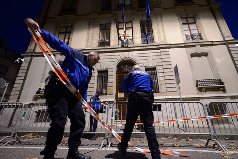 epa05025494 Geneva police officers install fences in front of the French Consulate in Geneva, Switzerland, 14 November 2015. At least 120 people have been killed in a series of attacks in Paris on 13 November, according to French officials. Eight assailants were killed, seven when they detonated their explosive belts, and one when he was shot by officers, police said. EPA/LAURENT GILLIERON