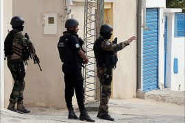 epa04459417 Members of the Tunisian security services take up a position around the area where police forces exchanged gunfire with alleged militants who had taken refuge in a house in the town of Oued Ellil, on the outskirts of the capital Tunis, Tunisia, 23 October 2014. According to Mohamed Ali Aroui, spokesman for the Interior Ministry, security forces surrounded a house containing a suspected terror cell believed to have been planning an attack during the upcoming parliamentary elections 26 October, and reports state as the opeation continued at least one Tunisian policeman was killed and several others wounded in an ensuing fire fight between Tunisian security forces and those inside the building. EPA/MOHAMED MESSARA