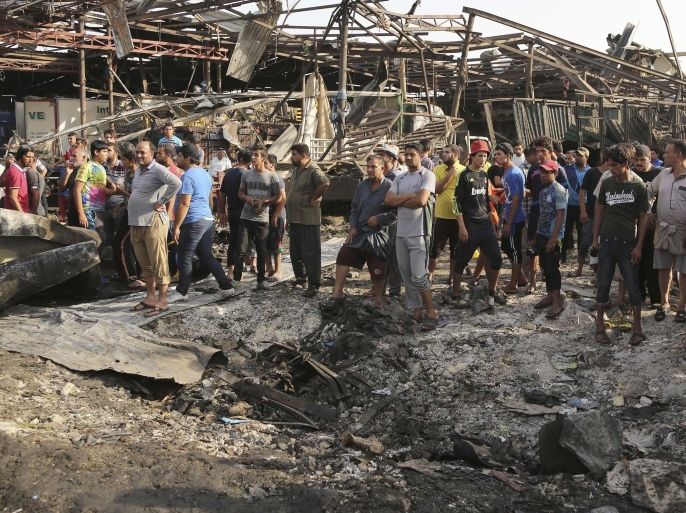 Civilians gather at the scene of a truck bomb attack in Jameela market in the predominantly Shiite neighborhood of Sadr City, Baghdad, Iraq, Thursday, Aug. 13, 2015. The massive truck bomb ripped through the popular Baghdad food market in the Iraqi capital's crowded neighborhood in the early morning hours on Thursday, killing tens of people, police officials said, in one of the deadliest single blasts in the capital in years. (AP Photo/Karim Kadim)