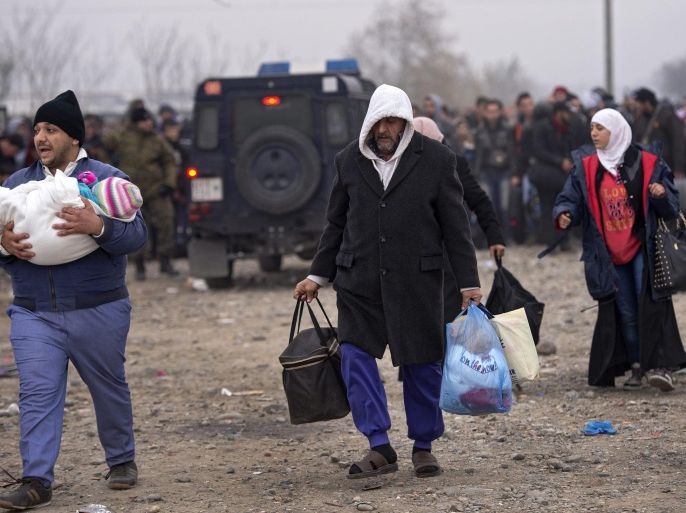 Refugees and migrants walk to enter the registration and transit camp after crossing border between Greece and Macedonia, near Gevegelija, The Former Yugoslav Republic of Macedonia, 21 November 2015. Macedonia, Serbia and Croatia on 19 November 2015 have started restricting access to migrants on the Balkan route to Syrians, Iraqis and Afghans. It is a part of a joint effort to reduce the number of asylum seekers streaming into the European Union.