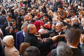Turkish President Tayyip Erdogan shakes hands with his supporters after voting at a polling station in Istanbul, Turkey November 1, 2015. Turks began voting on Sunday amid worsening security and economic worries in a snap parliamentary election that could profoundly impact the divided country's trajectory and that of President Tayyip Erdogan. The parliamentary poll is the second in five months, after the ruling AK Party founded by Erdogan failed to retain its single-party majority in June. REUTERS/Murad Sezer