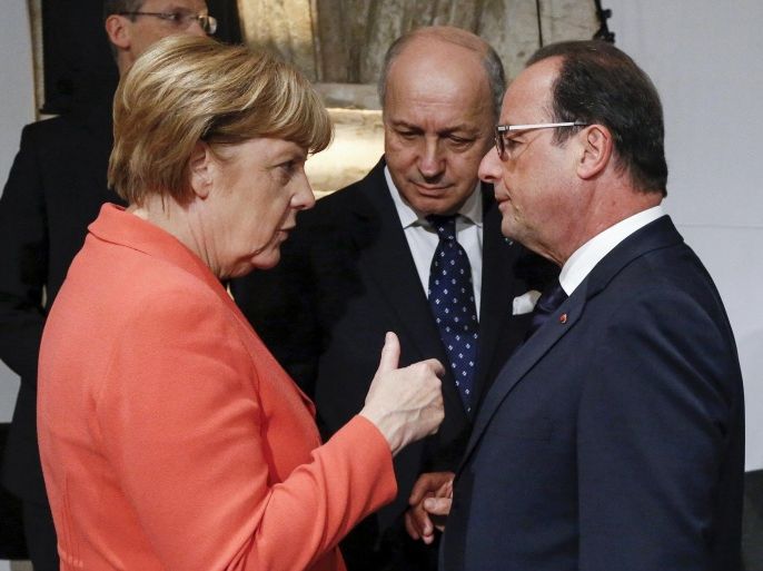German Chancellor Angela Merkel (L) talks with French Foreign Minister Laurent Fabius (C) and French President Francois Hollande (R) at the start of the Valletta Summit on Migration in Valletta, Malta, November 11, 2015. Leaders of the European Union met African counterparts on Malta on Wednesday, hoping pledges of cash and other aid can slow the flow of migrants crossing the Mediterranean from the world's poorest continent to wealthy Europe. REUTERS/Yves Herman