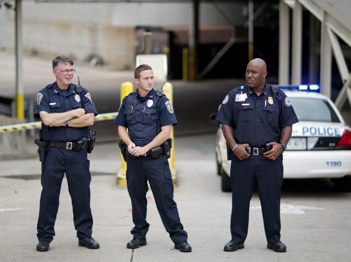 Police officers guard an entrance to Emory University Hospital after an ambulance arrived transporting an American that was infected with the Ebola virus, Saturday, Aug. 2, 2014, in Atlanta. A specially outfitted plane carrying Dr. Kent Brantly from West Africa arrived at a military base in Georgia. Brantly was taken to the Atlanta hospital. Another American with Ebola is expected to join him at the hospital in a few days. (AP Photo/David Goldman)