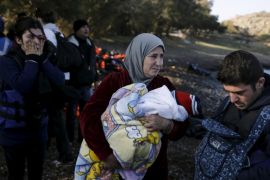 A Syrian refugee woman (C) cries as she holds a baby while refugees and migrants arrive on a boat on the Greek island of Lesbos, November 7, 2015. Since the start of the year, over 590,000 people have crossed into Greece, the frontline of a massive westward population shift from war-ravaged Syria and beyond. REUTERS/Alkis Konstantinidis