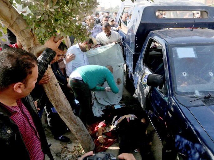 Egyptian police and emergency personnel cover the body of a victim at the site of an attack on policemen near Cairo, Egypt, 28 November 2015. Unknown gunmen shot dead four policemen in an attack near Cairo, the Interior Ministry said, the latest in a series of assaults targeting security forces in the country. The ministry added that two masked assailants riding a motorbike opened fire at a security checkpoint on a bridge in Giza, a city famed for the Pyramids. Egypt has seen a spate of deadly attacks, mainly against security forces, since the military's 2013 overthrow of Islamist president Mohammed Morsi following massive street protests against his rule.