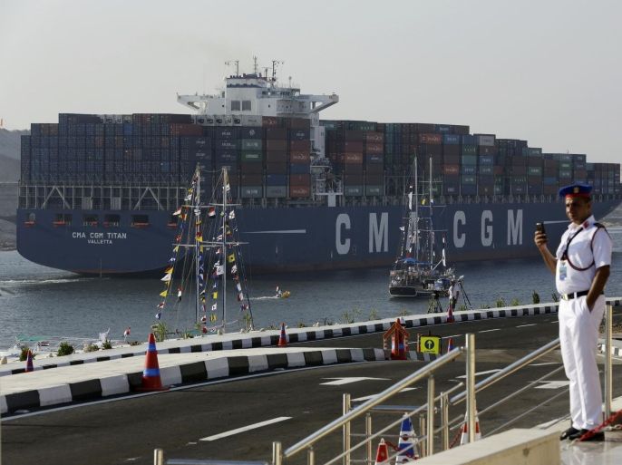 FILE - In this Thursday, Aug. 6, 2015 file photo, a cargo container ship crosses the new section of the Suez Canal after the opening ceremony in Ismailia, Egypt. Toll revenues for Egypt’s Suez Canal fell in September 2015, dampening hopes that a new parallel waterway -- which authorities claimed would more than double canal income in the next seven years -- will boost the economy in the immediate future. Data released on Monday, Oct. 25, 2015, by canal authorities shows that monthly revenue was $448.8 million in September, down some $13 million from the previous month. (AP Photo/Hassan Ammar, File)