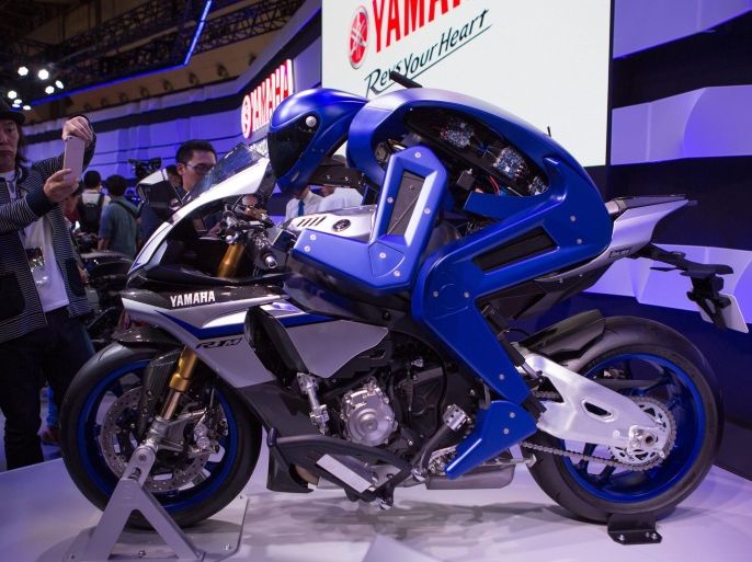 A visitor takes a photo Yamaha's Motorbot version 1 concept displayed at the 44th Tokyo Motor Show 2015 in Tokyo, Japan, 28 October 2015. The Tokyo Motor Show will be open to the public from 30 October to 08 November 2015.