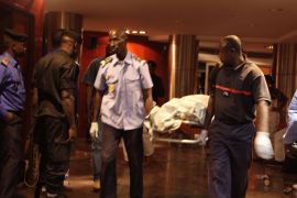 Mali security personal carry the body of a victim inside the Radisson Blu hotel after an attack by gunmen on the hotel in Bamako, Mali, Friday, Nov. 20, 2015. Islamic extremists armed with guns and grenades stormed the luxury Radisson Blu hotel in Mali's capital Friday morning, and security forces worked to free guests floor by floor. (AP Photo/Baba Ahmed)