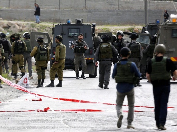 Israeli soldiers stand guard at scene of shooting at a check point out of AL-Fawwar refugee camp ,south of Hebron 25 November 2015. A Palestinian was killed and 2 Israeli soldiers were injured after the soldiers opened fire at the Palestinian after he stapped a soldier, army says.