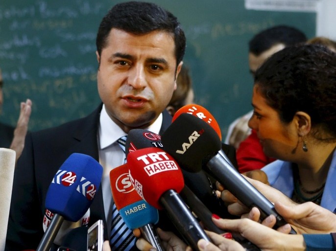 Selahattin Demirtas, co-chairman of the pro-Kurdish Peoples' Democratic Party (HDP), talks to the media before casting his ballot at a polling station during a general election in Istanbul, Turkey, in this November 1, 2015 file photo. The head of Turkey's pro-Kurdish opposition accused President Tayyip Erdogan of trying to create a "constitutional dictatorship" by pushing for an executive presidential system, and of fostering a climate of fear to win an election landslide. Selahattin Demirtas, who co-leads the Peoples' Democratic Party (HDP), told Reuters he believed the government could call a referendum as soon as this time next year on a new constitution that would transform what has been a largely ceremonial presidency. To match Interview TURKEY-POLITICS/KURDS REUTERS/Osman Orsal/Files