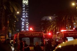 Police and ambulances are pictured near the scene of a bombing of a military bus in Tunis, Tunisia November 24, 2015. At least 12 people were killed on Tuesday after an explosion tore through a bus full of Tunisian presidential guards in an attack one source said was probably carried out by a bomber detonating his explosives in the vehicle. Ambulances rushed wounded from the scene and security forces closed off streets around Mohamed V Avenue, one of the major streets in the capital Tunis and where the charred wreckage of the bus lay not far from the interior ministry. REUTERS/Anis Mili