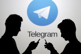 Two men pose with smartphones in front of a screen showing the Telegram logo in this picture illustration taken in Zenica, Bosnia and Herzegovina November 18, 2015. The mobile messaging service Telegram, created by the exiled founder of Russia's most popular social network site, has emerged as an important new promotional and recruitment platform for Islamic State. The service, set up two years ago, has caught on in many corners of the globe as an ultra-secure way to quickly upload and share videos, texts and voice messages. It counts 60 million active users around the world. Picture taken November 18. REUTERS/Dado Ruvic