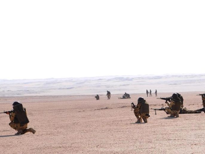 In this image released in Tuesday, Sept. 22, 2015 on the official Facebook account of the Egyptian military spokesman, soldiers take up combat positions during an operation near the Bahriyah Oasis in the Western Desert of Egypt. Spokesman Brig. Gen. Mohammed Samir says troops have killed 10 militants near the oasis, an area where Egyptian forces earlier this month mistakenly attacked a group of Mexican tourists, killing 12 people. (Egypt Army spokesman via AP)