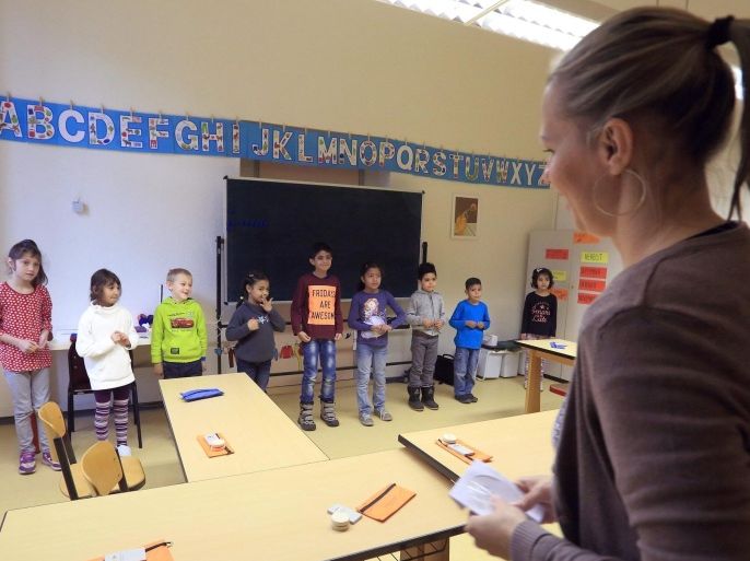 Beata Chlopik (R) teaches refugee children at a school in Dessau-Rosslau, Germany, 29 October 2015. Migrant children are attending German language classes at the school and many have already been integrated into other subjects.