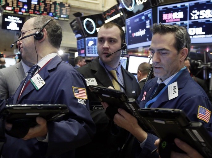 Traders Gordon Charlop, left, Nathan Wisniewski, center, and Gregory Rowe, work and on the floor of the New York Stock Exchange, Wednesday, Dec. 16, 2015. Stocks are opening higher, led by gains in banking shares ahead of an interest rate decision by the Federal Reserve. (AP Photo/Richard Drew)